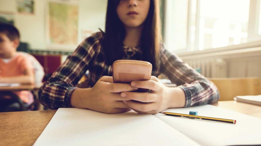 Girl on cell phone during class