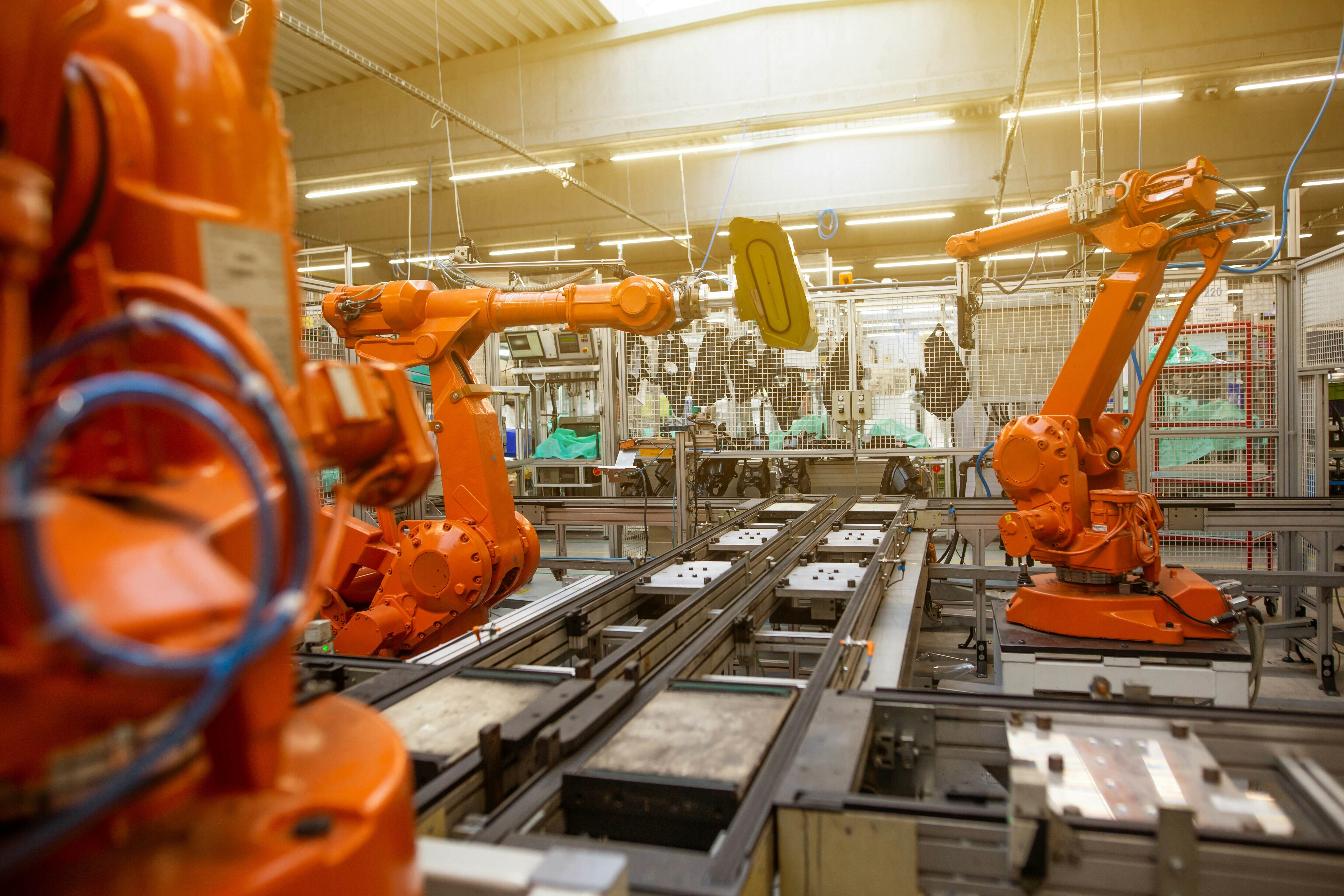 Automatic robots in an industrial factory for assembly automotive products.